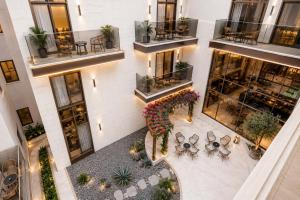 an overhead view of a building with plants and tables at Liora Al Yasmin District in Riyadh