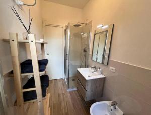 a bathroom with a toilet and a sink and a ladder at Casa del Sole in Versilia in Cinquale +18 photos