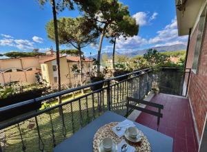 a table with a plate of food on a balcony at Casa del Sole in Versilia in Cinquale