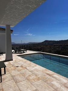 a swimming pool with a view of the mountains at Tía Pepa in El Gastor