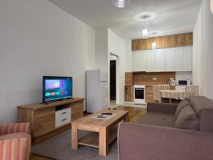 a living room with a couch and a flat screen tv at Przno in Pržno