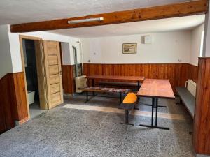a room with a bench and a table in it at Apartment sklep 33E in Hrušky +5 photos