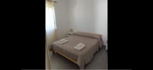 a bedroom with a bed with two towels on it at Residence la Duna in Castel Volturno