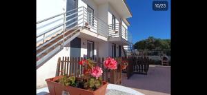 a house with flowers on the side of it at Residence la Duna in Castel Volturno