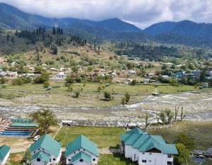 an aerial view of a village in the mountains at kanwal cottages safa resort in Dandpur