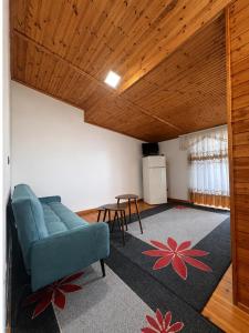 a living room with a blue couch and a table at Villa Hodo in Vlorë