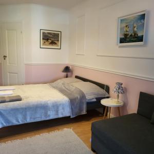 a bedroom with two beds and a table and a chair at Apartamenty przy Skwerku in Sztutowo +57 photos