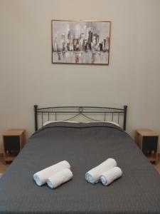 a bed with two pillows on top of it at Orange Grove in Plomari