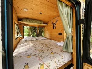 a bedroom with a bed in a wooden cabin at Tiny house - Bus insolite - avec Escape Game in Mignaloux-Beauvoir