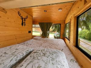 a bedroom with a bed in a log cabin at Tiny house - Bus insolite - avec Escape Game in Mignaloux-Beauvoir