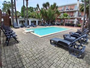 a swimming pool with lounge chairs next to a building at Hotel Giardino d'Europa in Rome