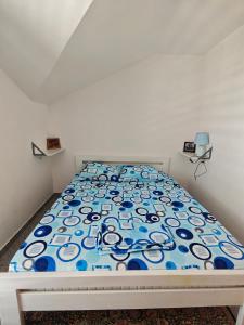 a bedroom with a bed with a blue and white bedspread at Apartmani Radovic in Bijela +57 photos