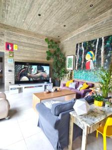 a living room with a blue couch and a tv at Casa del Quadro in Chios