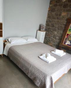 a bedroom with a bed with towels on it at Casa del Quadro in Chios +17 photos
