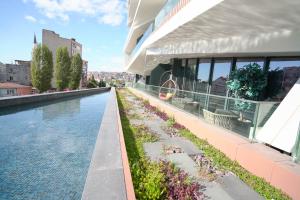 a swimming pool on the side of a building at Benesta Residence by NewInn in Istanbul