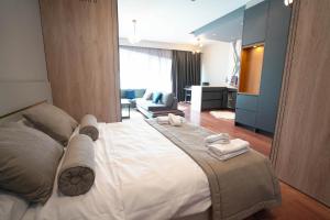 a bedroom with a large bed with towels on it at Benesta Residence by NewInn in Istanbul
