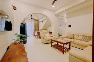 a living room with a couch and a table at Tiadoro Villa in Calangute