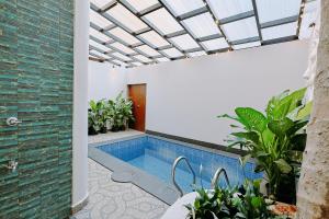 a swimming pool in a house with a skylight at Tiadoro Villa in Calangute