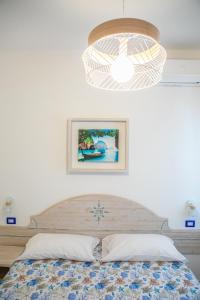 a bedroom with a bed and a light at Agriresort La Dragonara in Bacoli