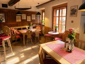 a dining room with tables and chairs in a restaurant at Café Pension Leopoldine in Hallstatt