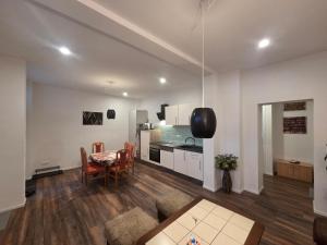 a living room with a table and a kitchen at Apartment am Saaleradwanderweg in Merseburg