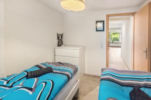 a bedroom with a bed and a dresser at Jolie Appartement Bei Kassel in Eiterhagen