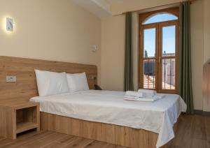 a bedroom with a bed with towels on it at The Mint Urla in Kuscular