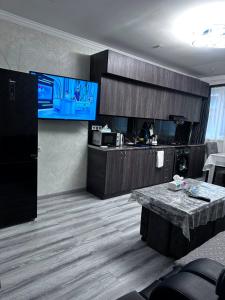 a living room with a kitchen and a table at Jermuk Cozy Apartment in Jermuk