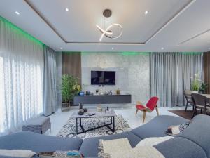 a living room with a couch and a table at Executive Cozy Suite at THE HIDDEN DOMUS I Saltpond Suite in Madina