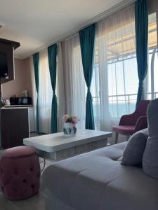 a living room with a couch and a coffee table at Апартаменти Генезис Ахтопол in Ahtopol