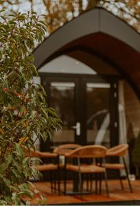 a group of chairs and tables in front of a building at luxury cottage with sauna in Milsbeek +7 photos