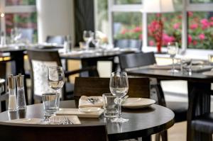a group of tables with wine glasses on them at Best Western Annesley House Hotel in Norwich