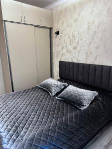 a bedroom with a bed with two pillows at Jermuk Cozy Apartment in Jermuk