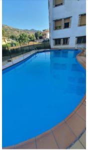an empty swimming pool in front of a building at La Ribera in Arroyo Frio