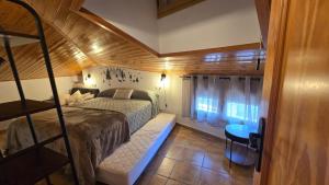 a bedroom with a bed in a room with a window at La Ribera in Arroyo Frio +16 photos