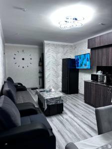 a living room with a couch and a tv at Jermuk Cozy Apartment in Jermuk