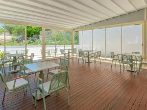 a cafeteria with tables and chairs and windows at The Mint Urla in Kuscular