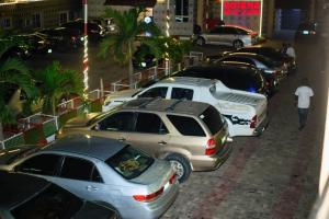 a row of cars parked in a parking lot at Rotana Hotel and Suits in Ilorin