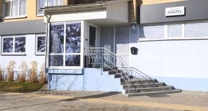 a building with a staircase in front of a door at City Center Hostel in Mažeikiai