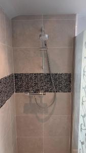 a shower with a shower head in a bathroom at The Burrow in Kendal +23 photos