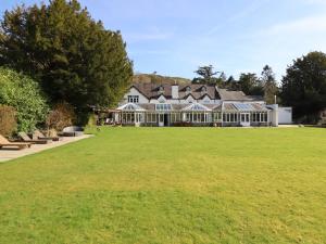 a large house with a large lawn in front of it at Plas Dolguog in Machynlleth