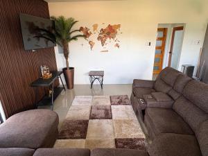 a living room with a couch and a map on the wall at Suite Seven in Mount Pleasant
