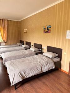 a group of four beds in a room at Safari Stop Hostel in Almaty