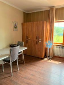 a room with a desk and a large wooden door at Safari Stop Hostel in Almaty
