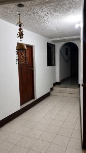 an empty hallway with a door and a hallway with stairs at Casa Volcán Granada in Granada