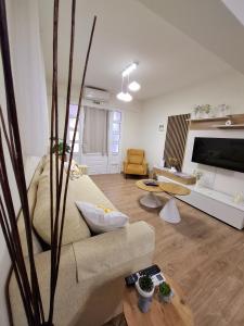 a living room with a couch and a table at Mylo Casa Karfas in Chios