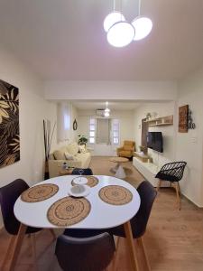 a living room with a white table and chairs at Mylo Casa Karfas in Chios