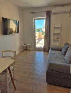 a living room with a couch and a table at Guesthouse Maro in Povljana