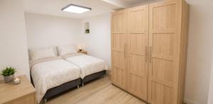 a bedroom with a bed and a large closet at Dominikówka in Dominikowo