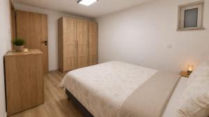 a bedroom with a bed and a wooden cabinet at Dominikówka in Dominikowo +21 photos